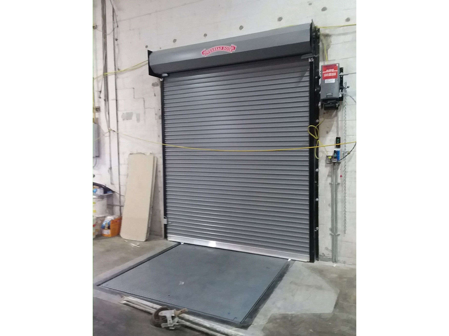 Rolling steel door with dock leveler