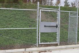 Panic bar exit device on fence