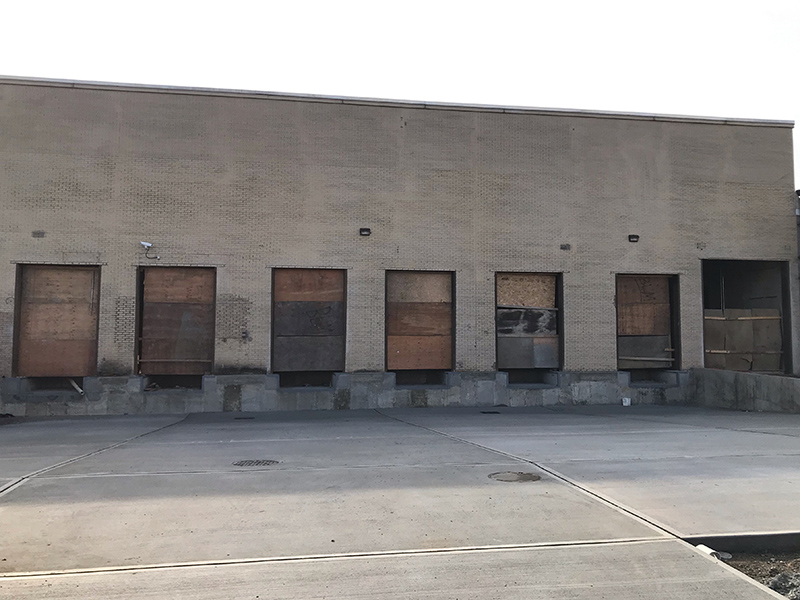 Distribution facility rolling doors installation before outside photo